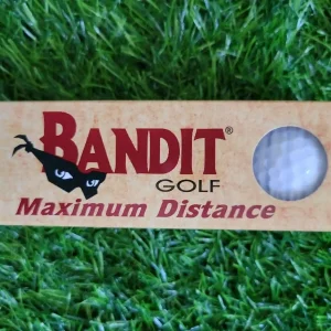 a golf ball in a box on grass